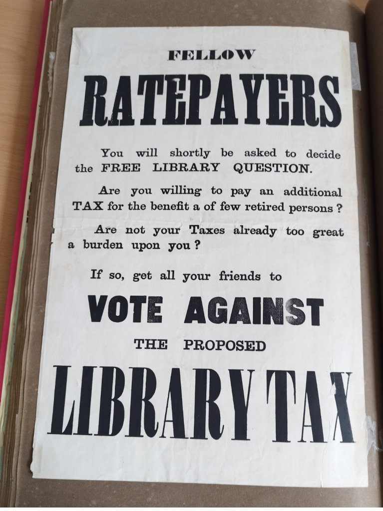 A3 black and white poster in scrapbook. Main words: Fellow Ratepayers Vote against the proposed Library Tax