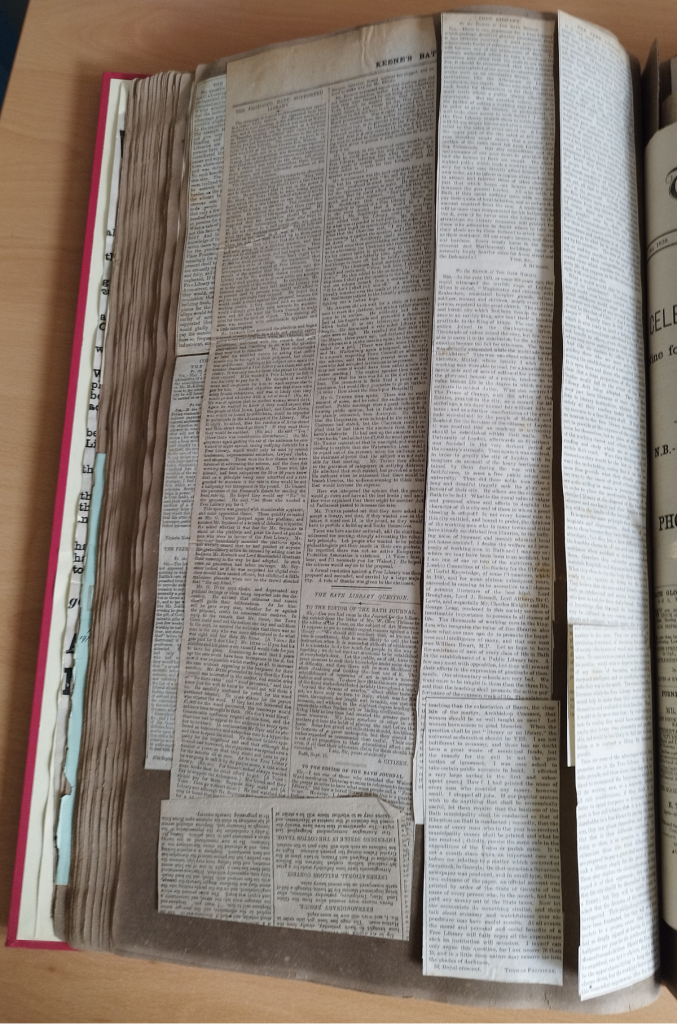 Large scrapbook page full of newspaper cuttings