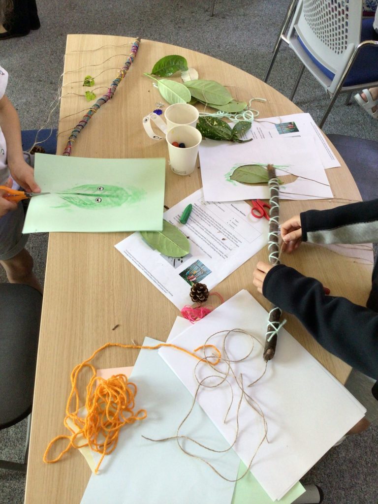 sticks wrapped in yarn and other craft materials