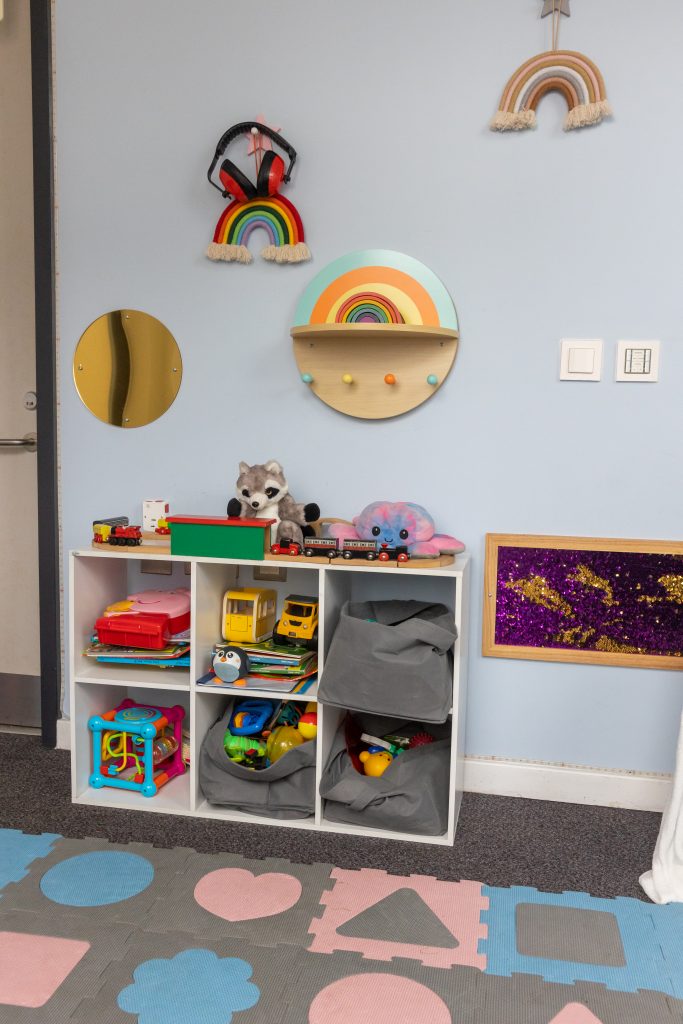 items attached to wall and shelving full of toys