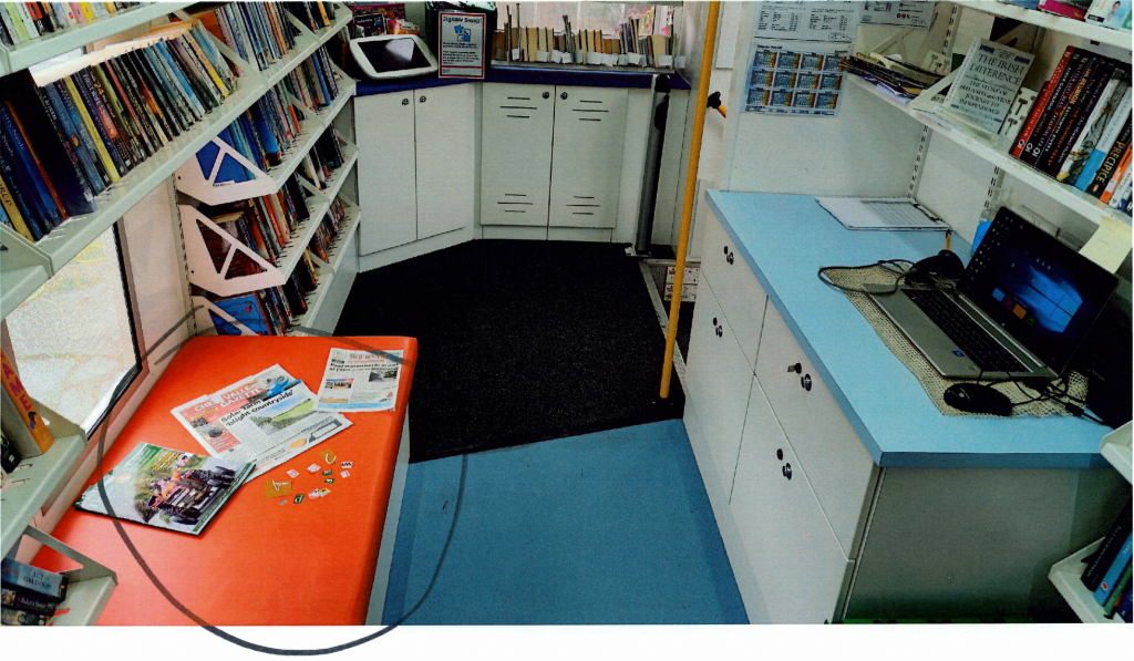 photo of inside mobile library, a large circle drawn around a pile of magazines with the letters cut out, and letters spread about