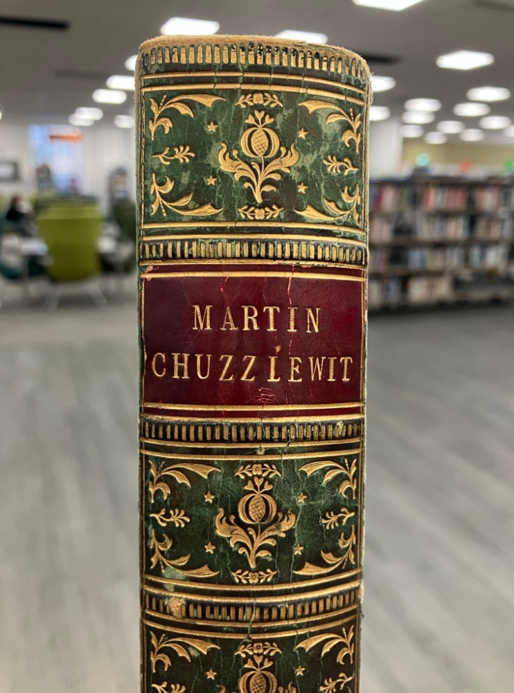 Spine of Martin Chuzzlewit, green and red leather with gold decoration.