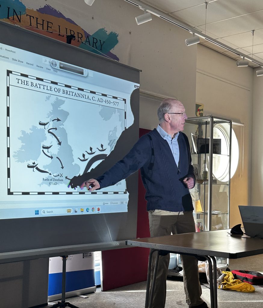 Man stood pointing at a map on a projector screen