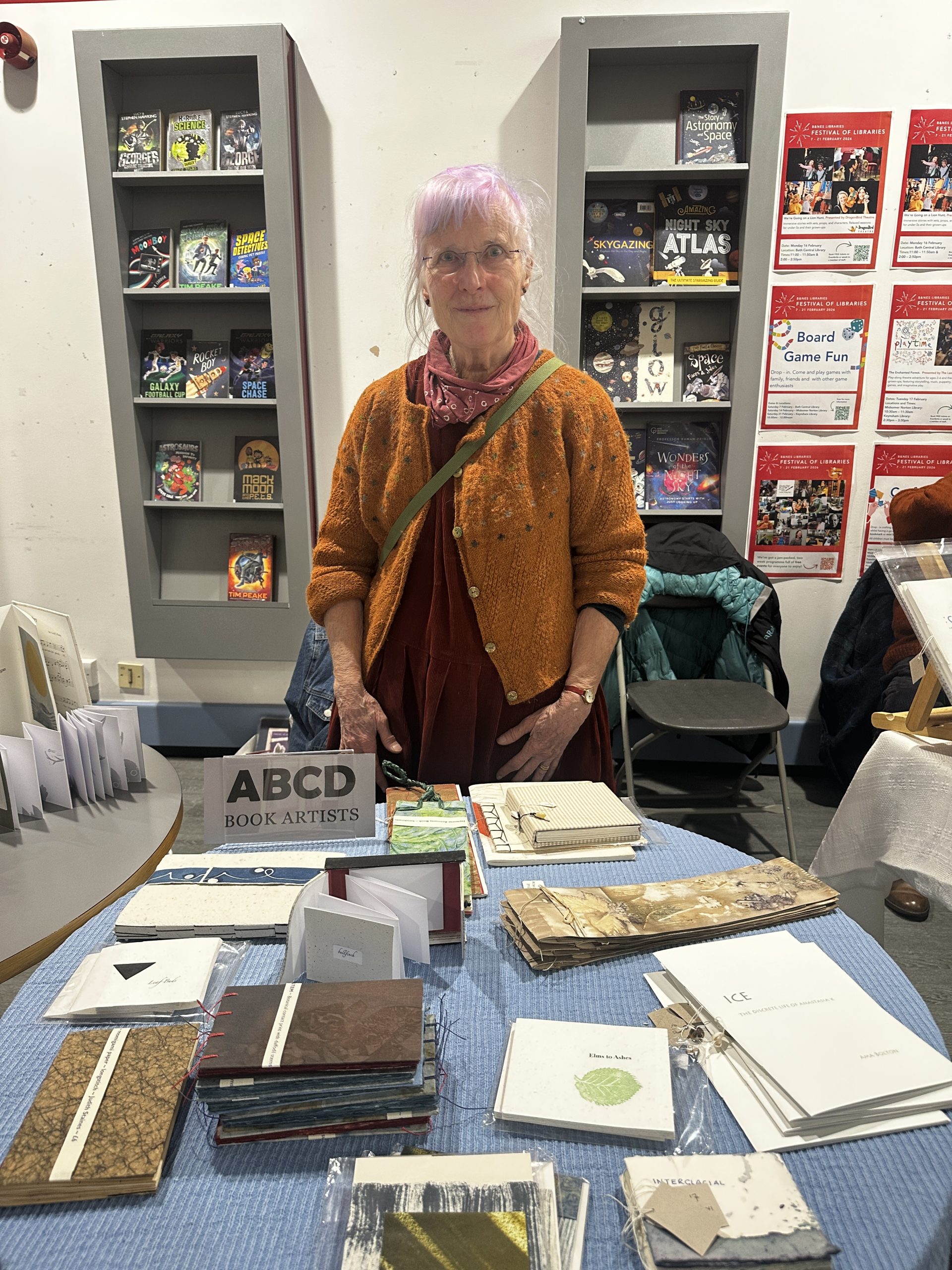 woman stood behind display of hand made book
