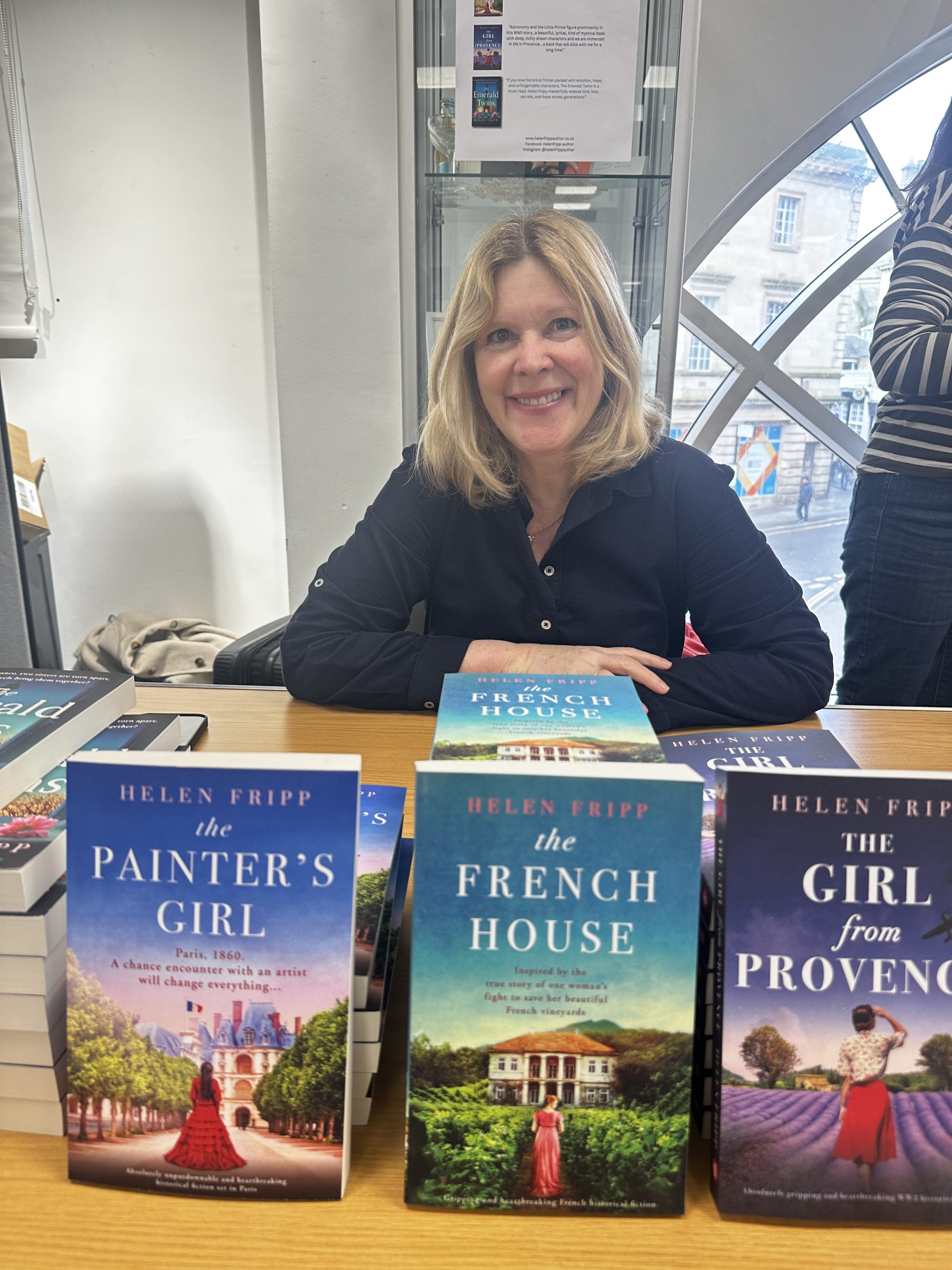 woman sat behind book display