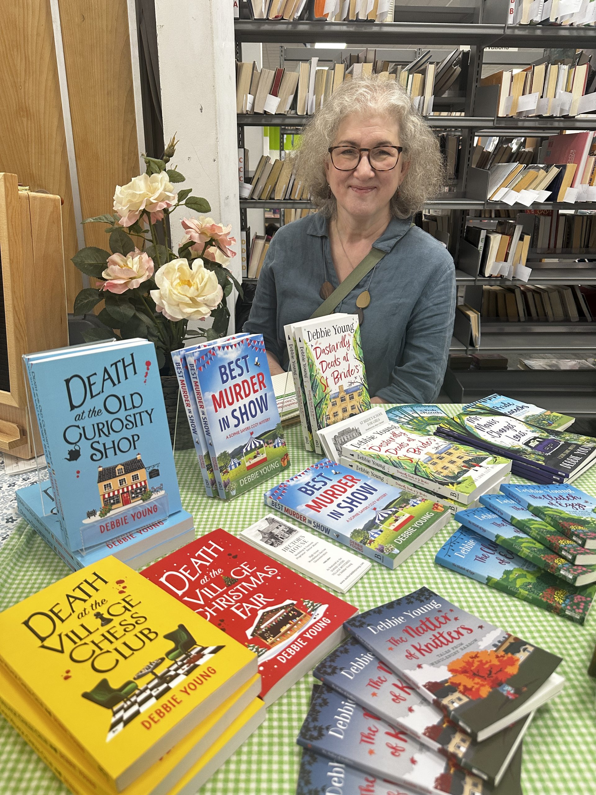 Woman sat behind display of crime novels