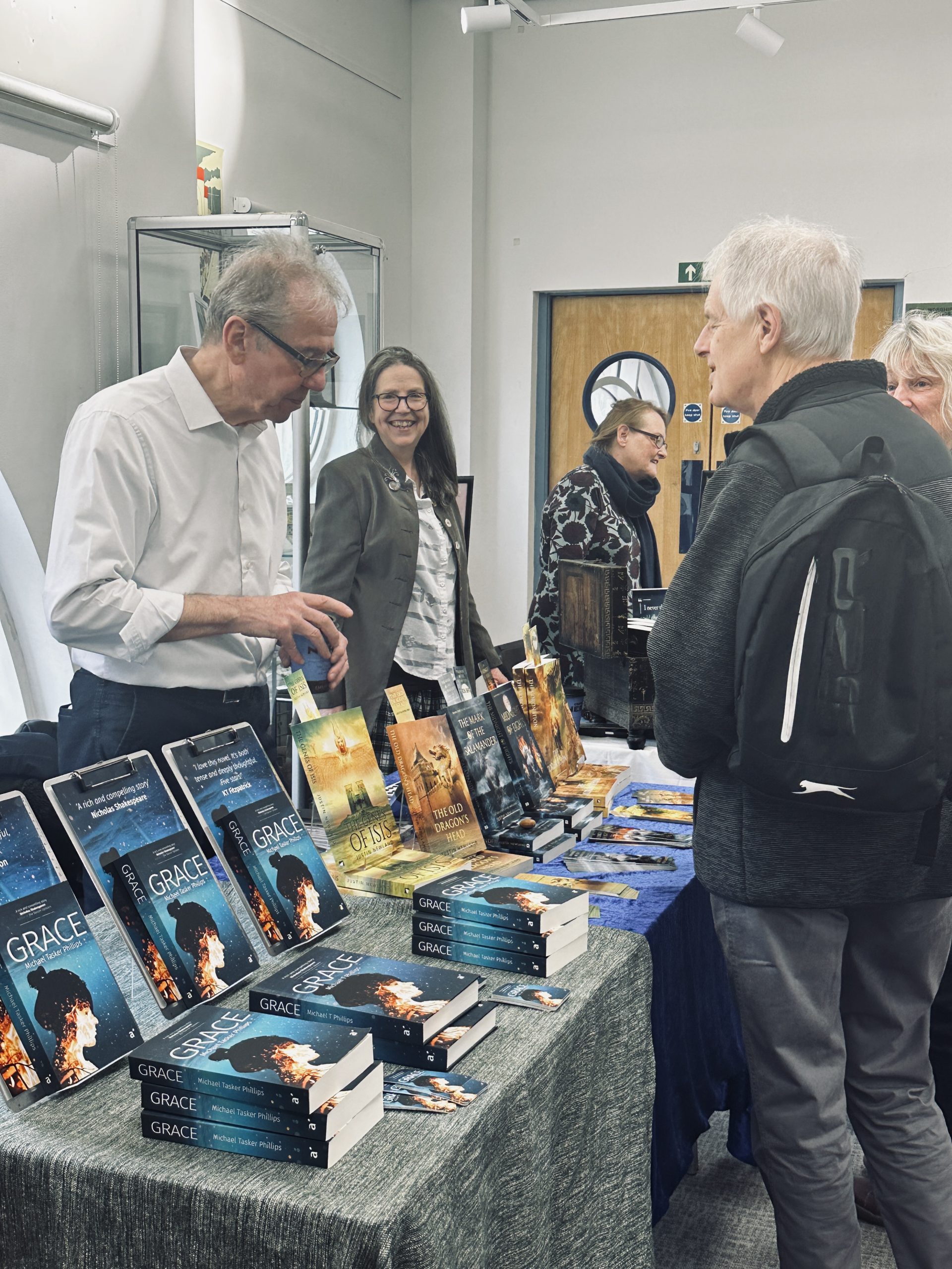 Man talking to others over book display