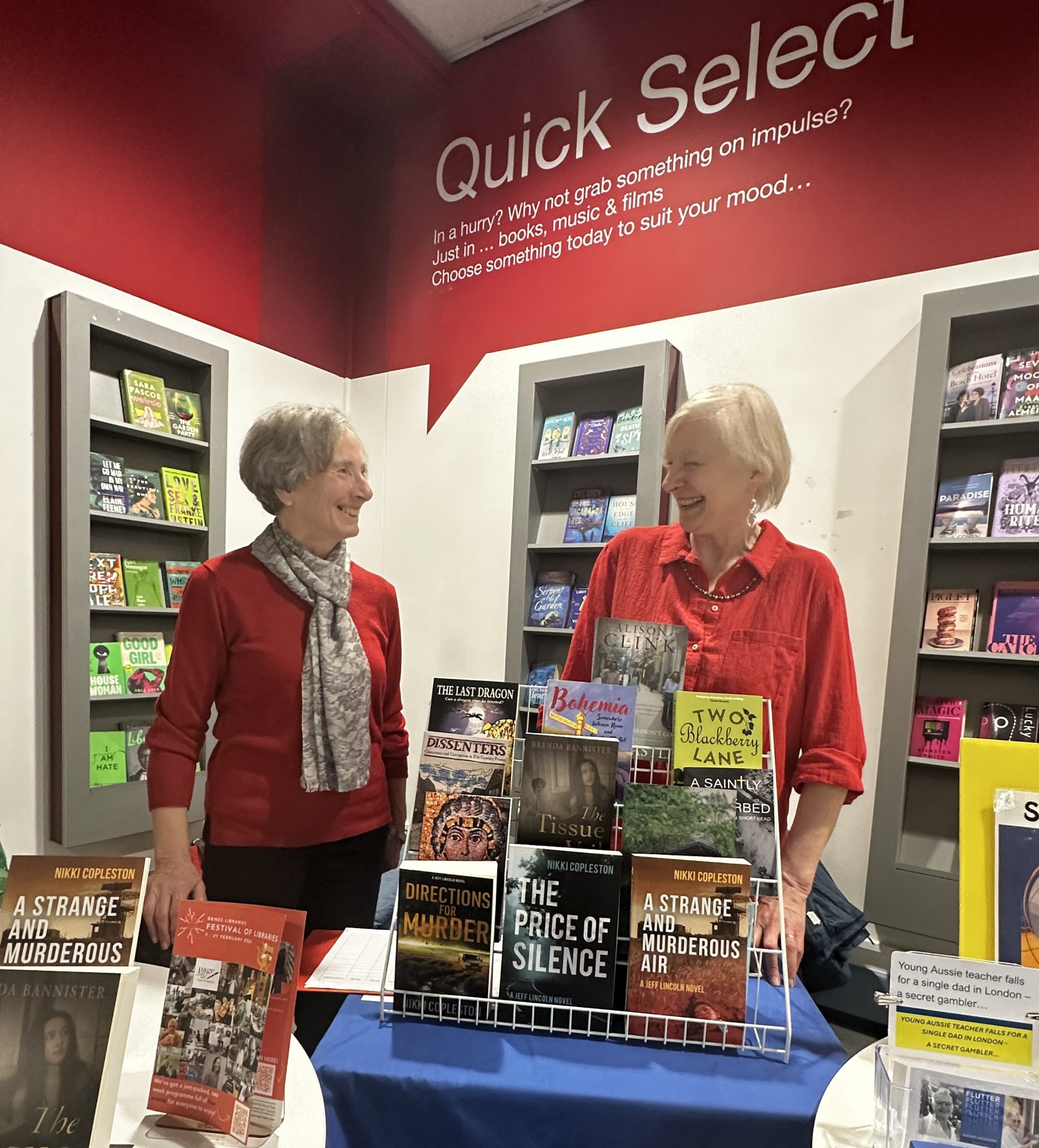 two women chatting behind display of books