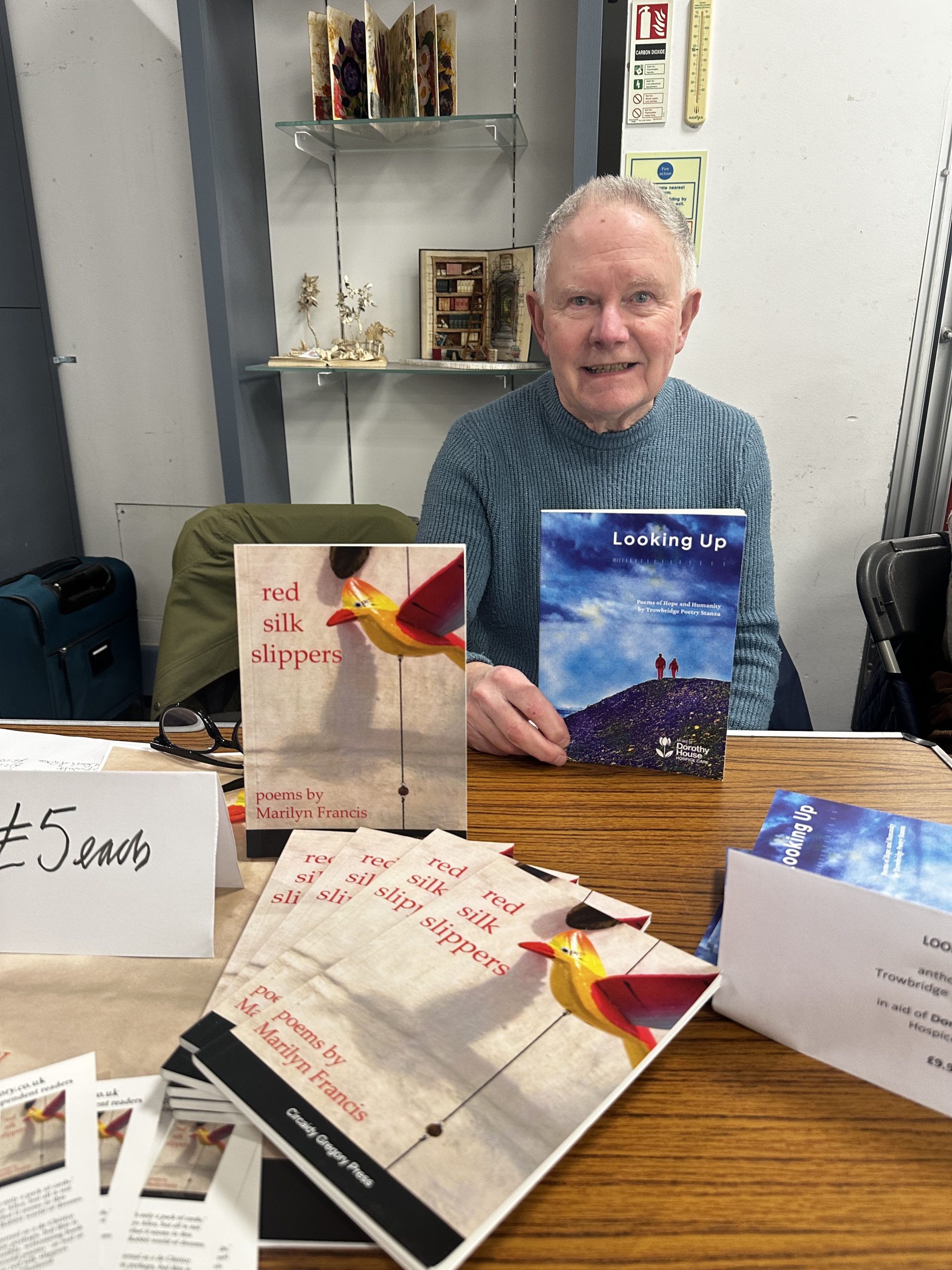 older man with selection of different books